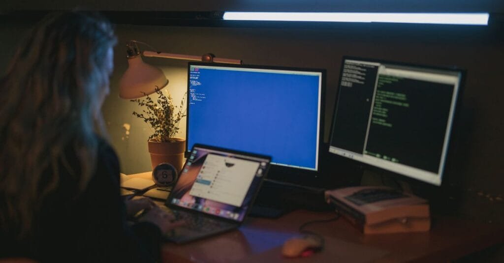 Person working at multiple screens