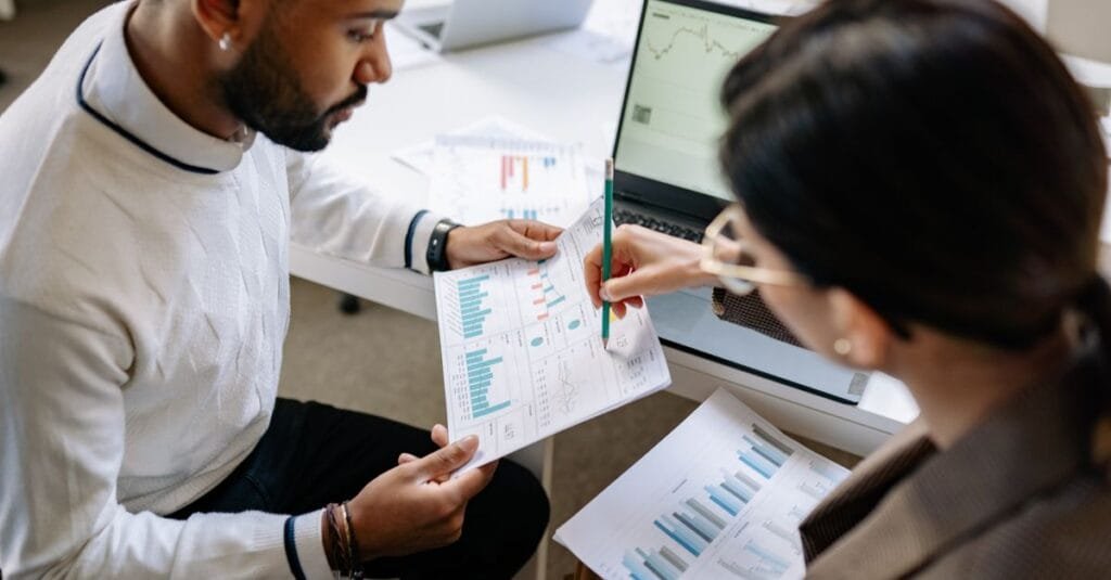 Two people reviewing analytics reports