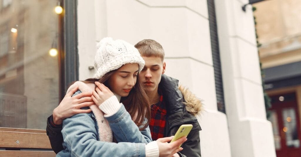 Two people looking at a phone
