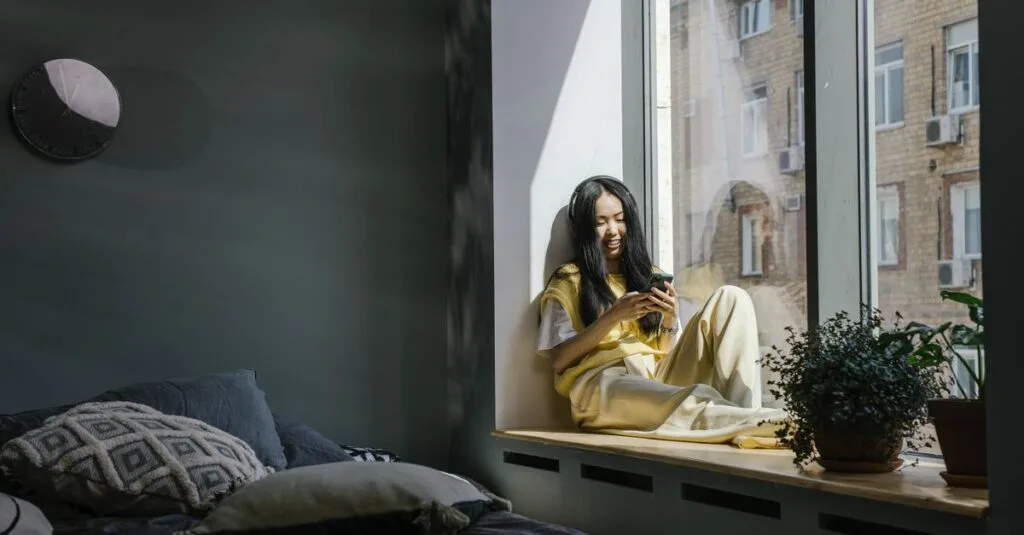 Woman with headphones smiling at a phone
